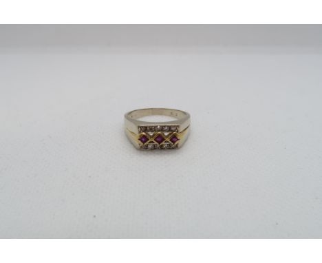 An 18ct (hallmarked) bi colour ring with rubies and diamonds - ring size O/P - weight approx 5.3 grams 