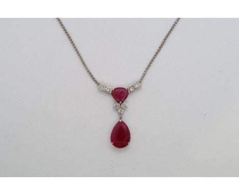 A 9ct white gold (hallmarked) diamond and ruby drop necklace - total diamond weight approx 1.7ct - the pear shaped ruby drop 