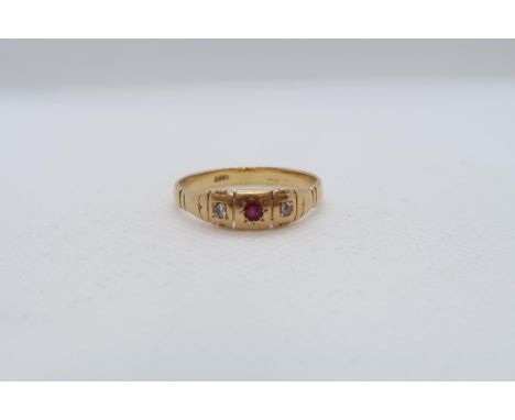 An 18ct yellow gold (hallmarked) ring with diamonds and ruby - ring size V - approx weight 4.6 grams 