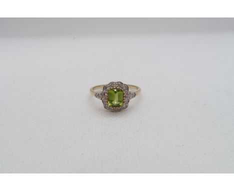 A 9ct yellow gold Peridot and diamond ring with diamond shoulders - head size approx 11mm x 11mm - ring size M/N 