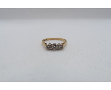 An 18ct yellow gold (hallmarked) three stone diamond ring size R - weight approx 2.8 grams 