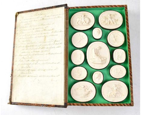 An early 19th century Italian Grand Tour faux book of plaster intaglios, each hinged cover enclosing twenty-five medallions, 