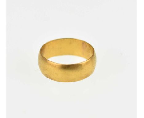 A 22ct gold wide wedding band, size K, approx. 4.6g.