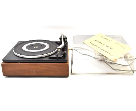 GARRARD; a model SP25 Mk 3 turntable with wood-effect base and plastic cover, 20 x 35 x 30cm.Condition Report: The seller sta