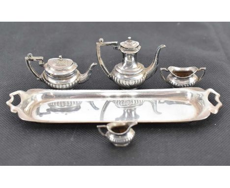 JOHN ROSE; a George V hallmarked silver five-piece dolls' tea service comprising long tray, length 15cm, coffee pot, height 4