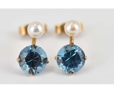 A pair of 9ct yellow gold stud earrings with brilliant cut claw set topaz and small seed pearl, approx. 1.6g.