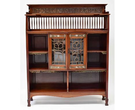 SHAPLAND &amp; PETTER, BARNSTAPLE; an Art &amp; Crafts walnut bookcase, with three-quarter galleried top shelf with inset cop