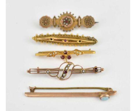 Five gold Victorian-style brooches, comprising a 15ct gold torpedo-shaped example set with three tiny rubies, with beaded out