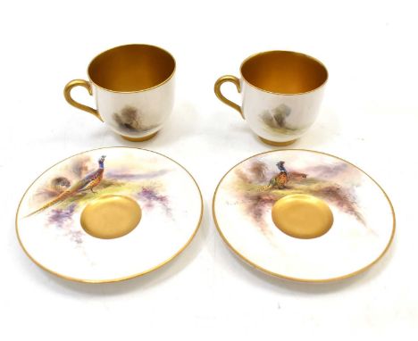 JAS STINTON FOR ROYAL WORCESTER; two pairs of hand-painted cabinet cups and saucers decorated with pheasant and woodland scen