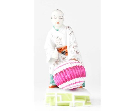 AUGARTEN WEIN, VIENNA; a 20th century porcelain figure of a Chinese boy with a pink and white lantern, printed marks, no. 294
