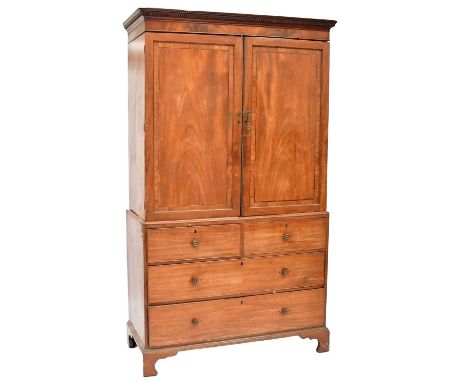 A George III mahogany linen press with dentil moulding, converted to a wardrobe (therefore lacking slides), the base with two