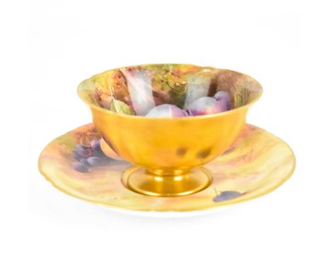 ROYAL WORCESTER; a teacup and saucer hand-painted with fallen fruit, by Horace Price, factory marks to base, cup height 6cm, 