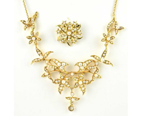 An Edwardian 15ct yellow gold seed pearl fringe necklace of hinged floral sections, circa 1910, on bolt ring fastener, length
