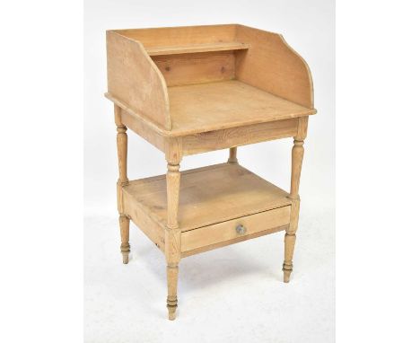 A late 19th/early 20th century pine washstand with three sides and shallow shelf above central void to single drawer on turne