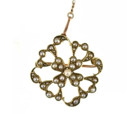 An Edwardian 9ct gold openwork seed pearl clad brooch, with gold safety chain, diameter 2.7cm, approx. 4.6g.