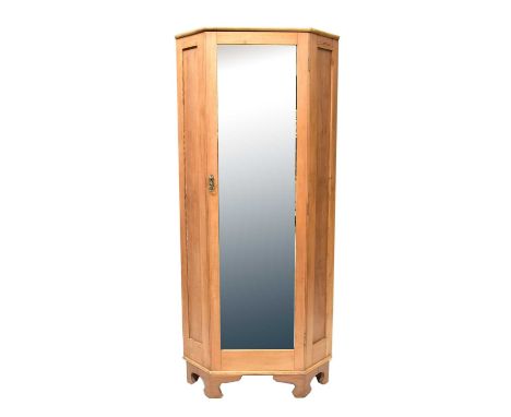 A pine corner wardrobe with bevelled mirror glass door and raised on bracket feet, 201 x 89 x 62cm.Condition Report: Overall 