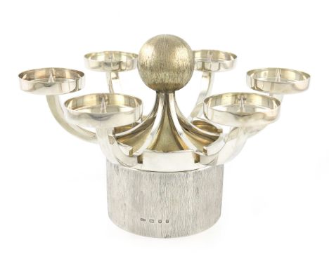 By Christopher Lawrence, a modern parcel-gilt silver centre-piece, London 1973, the base formed as a circular box with textur