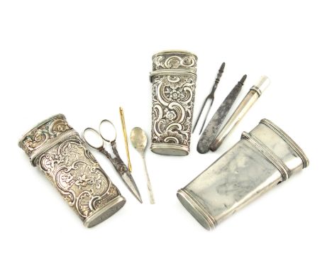 A collection of three antique silver etui cases, one of plain form, cover a.f, plus two with embossed foliate scroll decorati