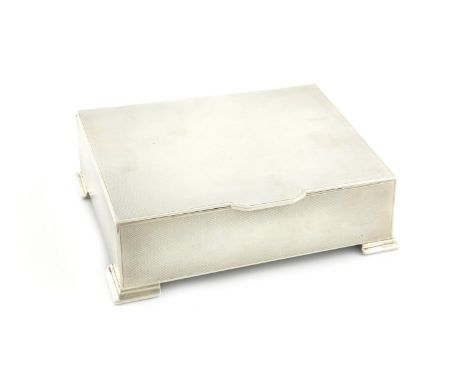 A silver cigarette box, by Mappin and Webb, Birmingham 1937, slanted rectangular form, engine-turned decoration, wood lined, 