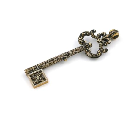 A Victorian gold and enamel novelty pencil, unmarked, modelled as a key, with black and white enamel scroll decoration, with 