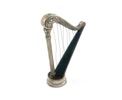 An Edwardian novelty silver hat pin stand, by S. Mordan and Co, Chester 1905, modelled as a harp, with a fluted column and tu