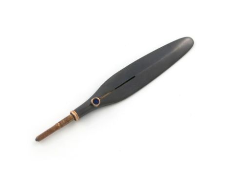 A gold-mounted gun metal combination pencil and paper knife, unmarked, plain feather form, the slider set with a blue stone, 