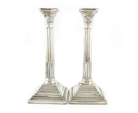 A pair of modern silver Corinthian column candlesticks, by Albert Sydenham, Birmingham 1960, fluted columns, on stepped squar