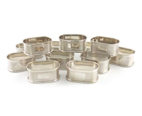 A set of twelve modern silver napkin rings, by W I Broadway &amp; Co, Birmingham 1986/87, rounded rectangular form, with engi