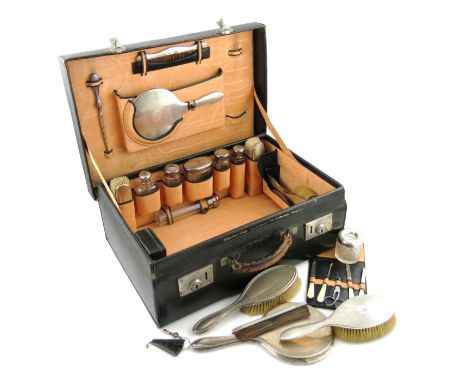 λA silver travelling dressing table set, by Alexander Clark, Birmingham 1925, with engine-turned decoration, comprising a mir