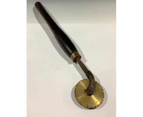 Tools - a bookbinder’s finishing tool, decorative brass roll with wooden handle, 56cm 
