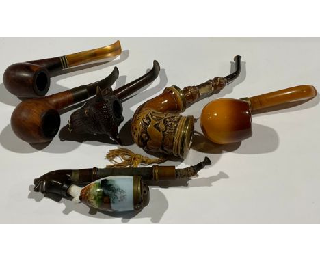 A German pipe, the chamber depicting leaping deer; another depicting a galloping horse, engraved ‘1803’; others (6) 