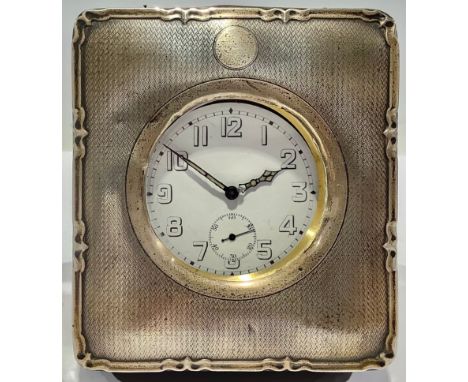 A George V silver engine turned rounded rectangular travelling pocket watch case, vacant cartouche, easel standing Morocco le