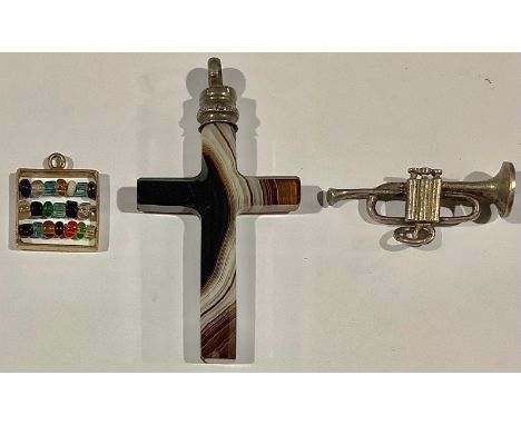 A 9ct gold charm, as an abacus; an agate crucifix; a silver coloured metal charm, as a trumpet (3) 