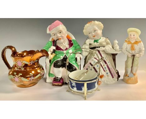 A pair of late 19th century continental Darby and Joan tobacco jars and covers, he smoking a pipe, she taking tea; a Victoria