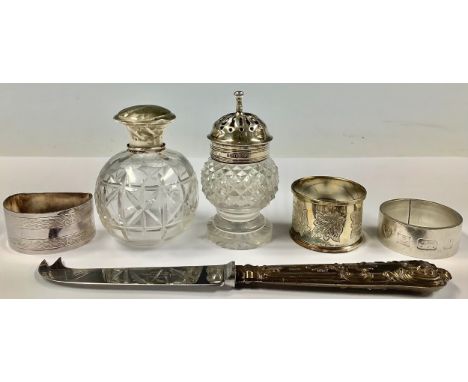 A silver napkin ring, Birmingham 1975; other silver napkin rings; a Georgian silver mounted cut glass sifter, 9cm high; etc (