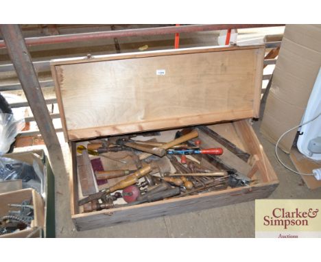 A wooden toolbox and contents of tools