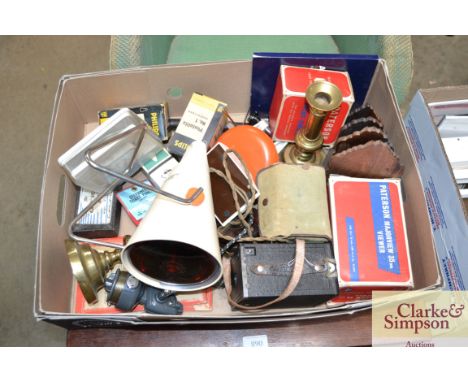 A box of various sundry items to include a fishing reel; a pair of brass candle sticks; boxed Brownie camera; Philips infrare