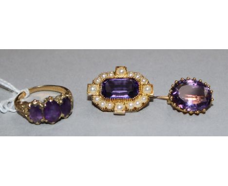 Two Victorian amethyst and gold brooches and a similar three stone ring.