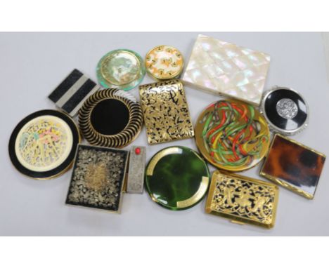 A Victorian mother of pearl purse, lipstick case, twelve compacts, etc