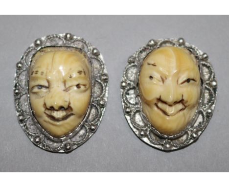 A pair of silver mounted ivory Japanese masks, early 20th century, 3cm.