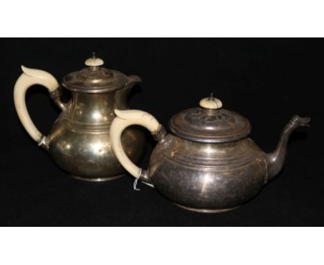 An ivory handled silver teapot and hot water jug by Walker & Hall, London, 1935, gross 59 oz.