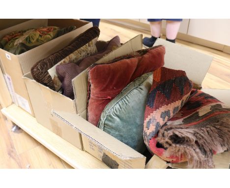 A collection of wool worked cushions, rug and textiles