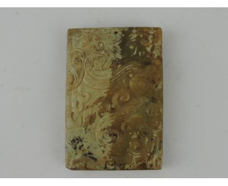 A carved jade rectangular pendant, decorated with a dragon, H. 8cm.