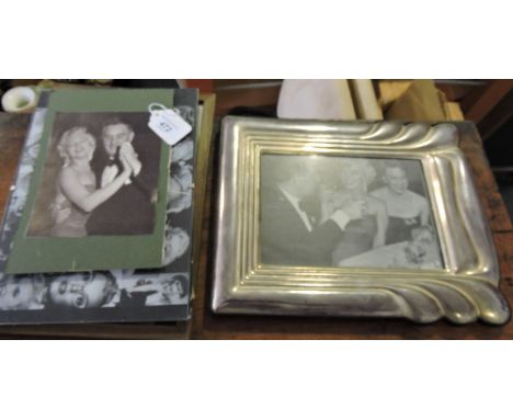 A collection of monochrome Marylin Monroe photographs together with a mirror