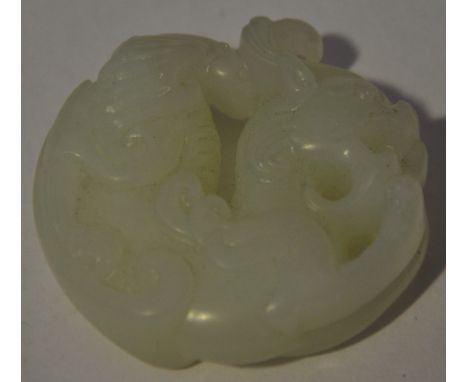 A mutton-fat jade pendant, carved in the form of a dragon, D. 5cm.
