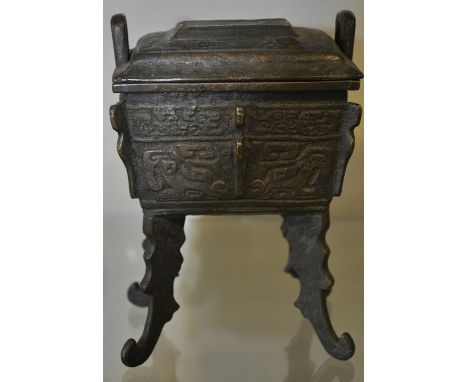 A Chinese cast bronze koro with detachable cover of rectangular form on 4 scroll feet