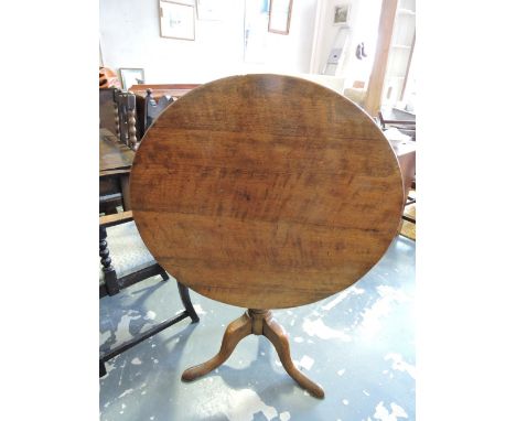 An early 19th century oak tea table with circular tilt top on turned vase column and angular cabriole tripod, Dia 87 cms