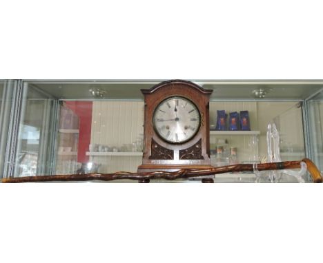 An Edwardian mahogany cased mantel clock, the silvered dial set out in Roman numerals and fitted with a movement striking a g