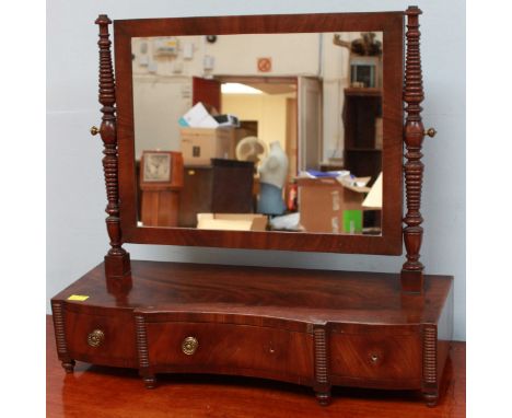 A good quality 19th century flame mahogany-veneered platform mirror, with graduated ring-turned mirror supports, inverted bow