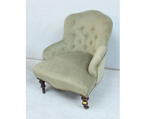 A Victorian mahogany button back tub chair, with green upholstery and supported on turned legs.